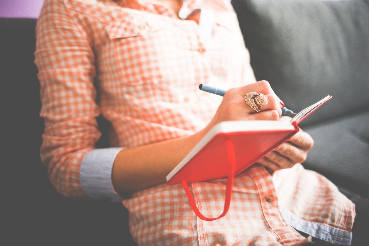 A woman writing a plan.