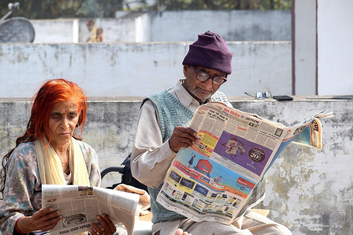 An old couple reading newspapers.