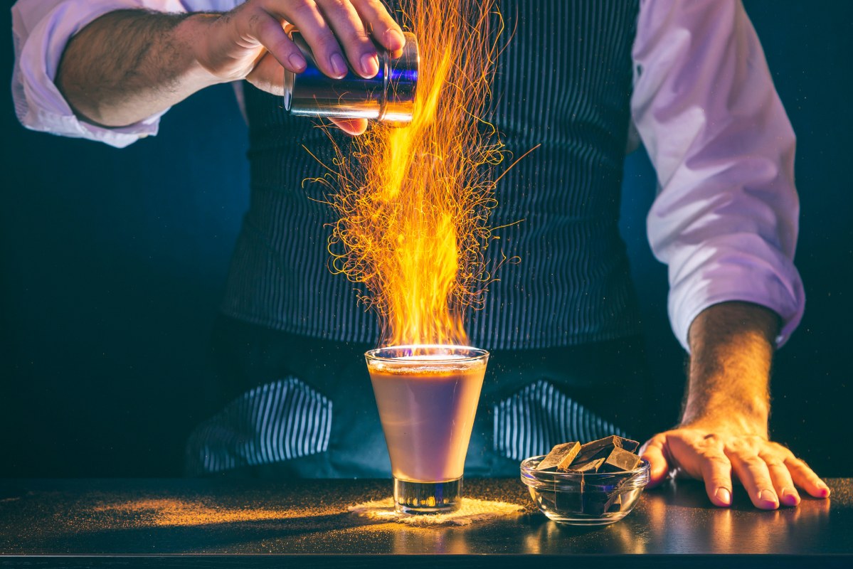 Bartender making a cocktail on fire.