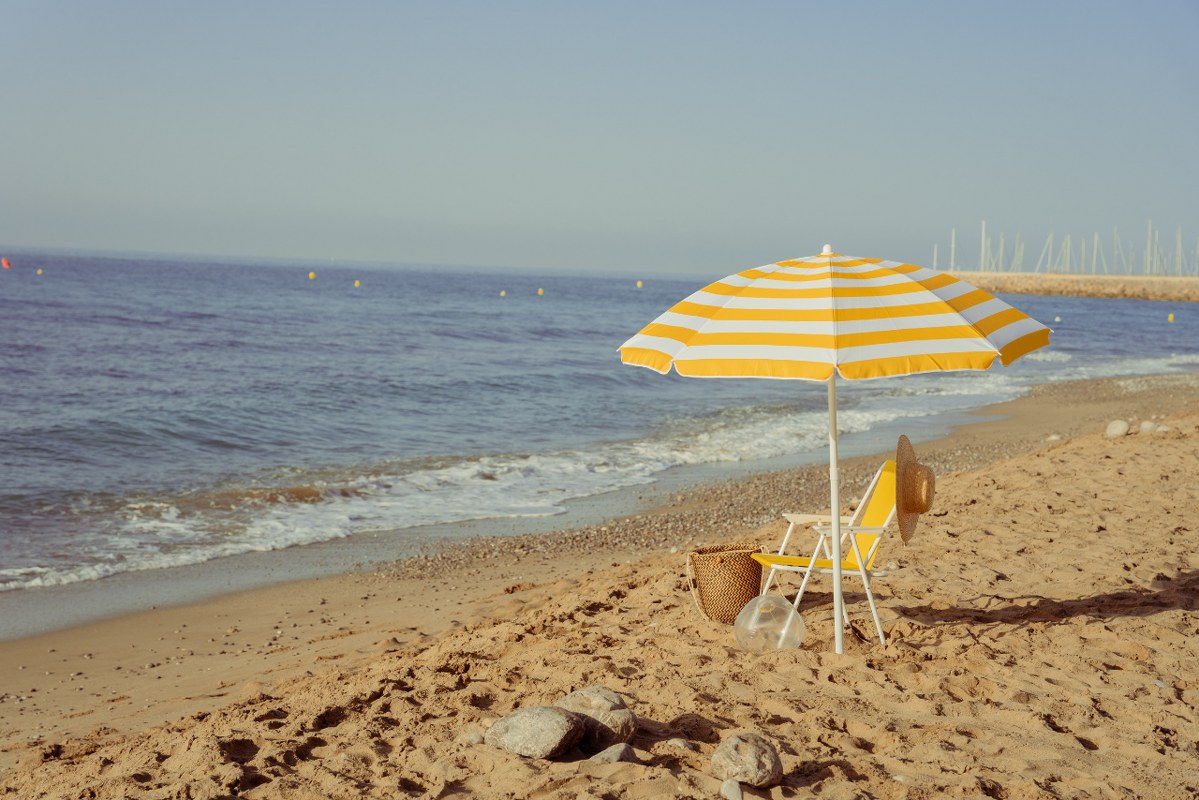 Beach Chair and Umbrella at the Seashore.