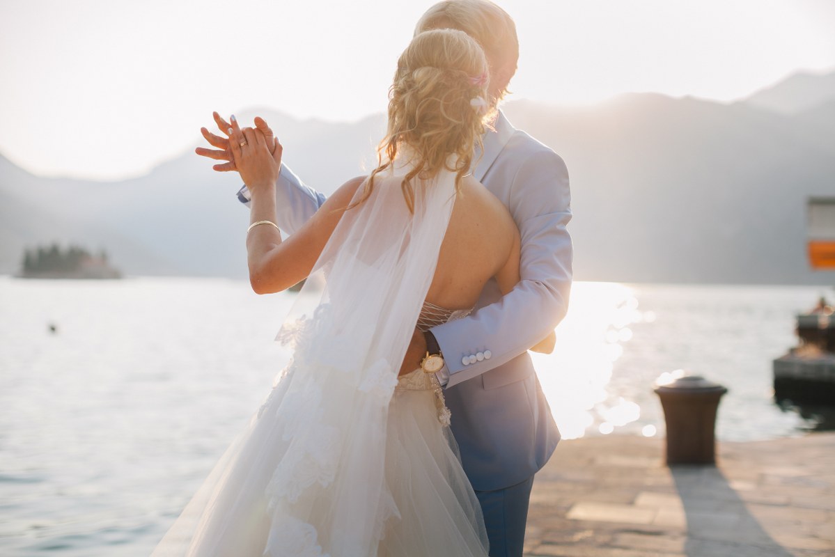 Behind scene of sweet couple dancing at wedding.