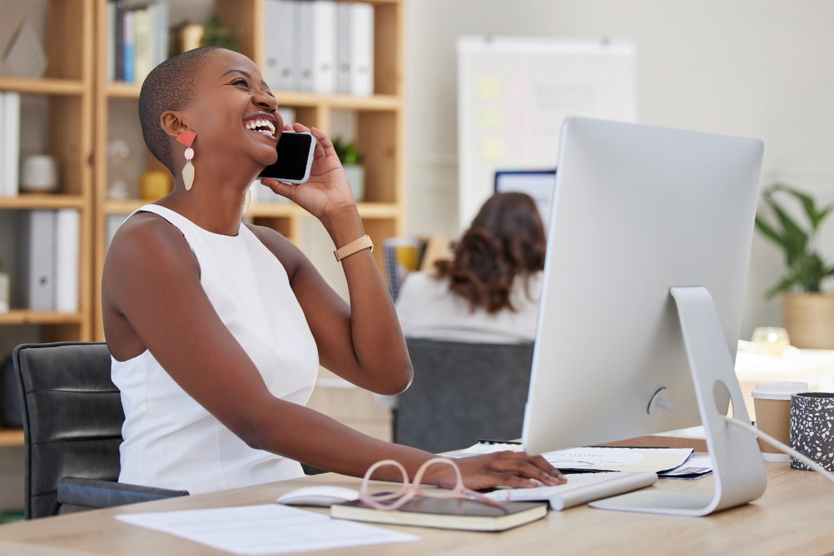 Black Business Woman on phone building rapport with Customer.