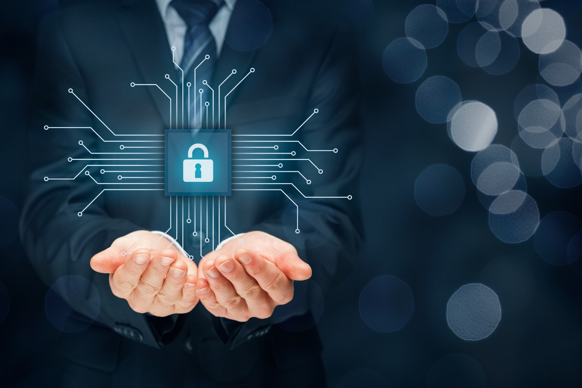 Business person's hands with hologram of cybersecurity.
