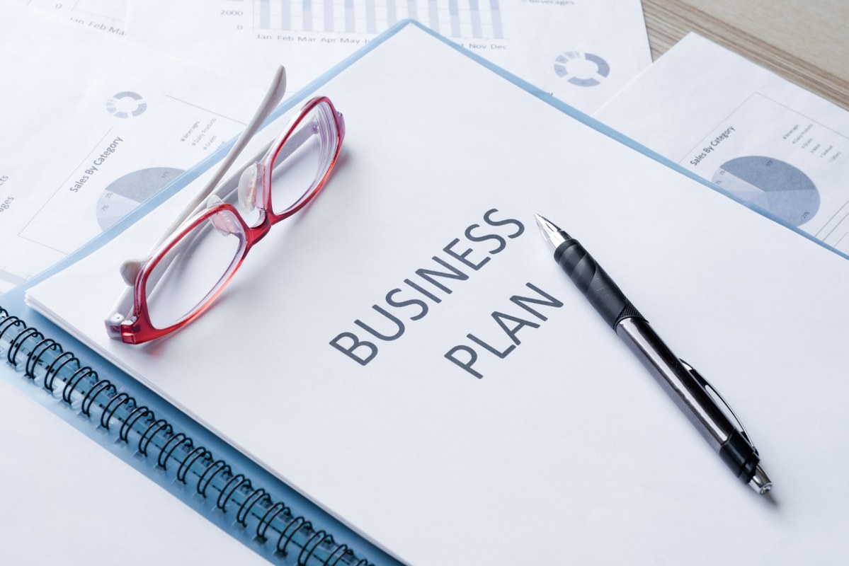 Business plan document and pen.
