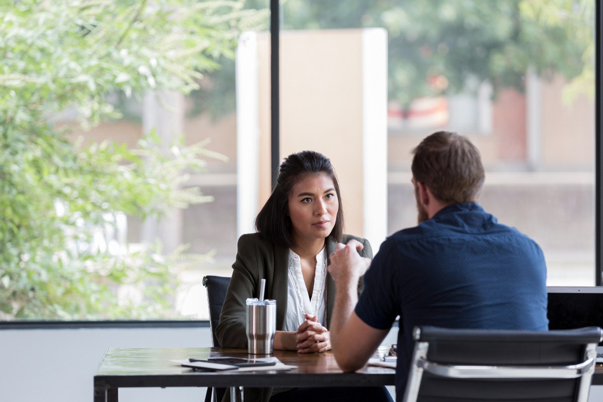 Business woman listening attentively to client.