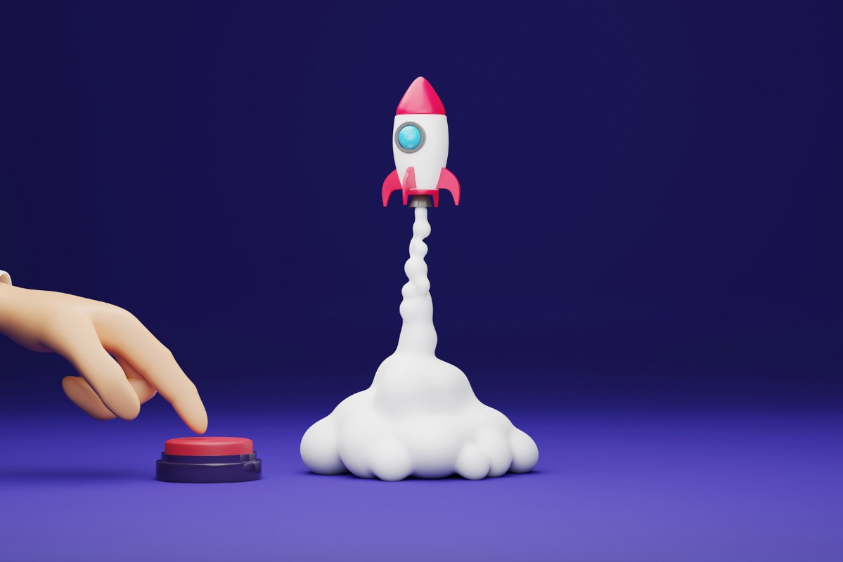 Businessman hand pressing start button red rocket launch purple.