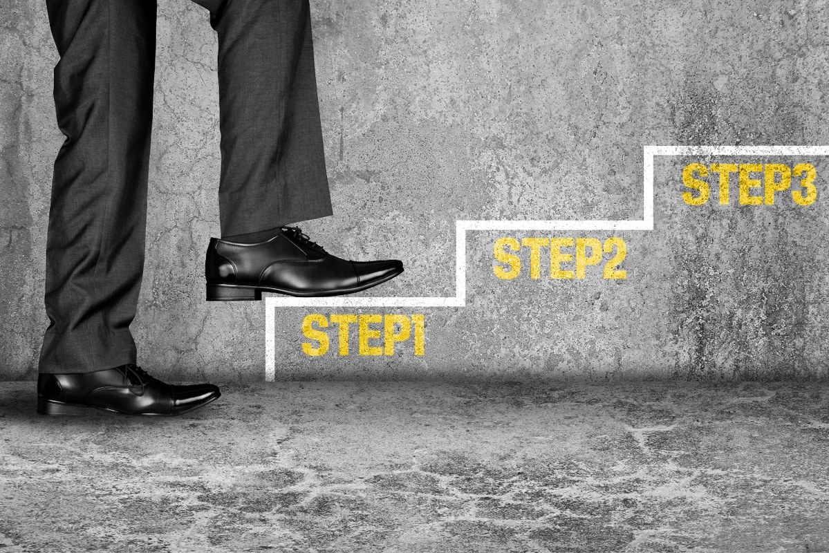 Businessman stepping on his first step.