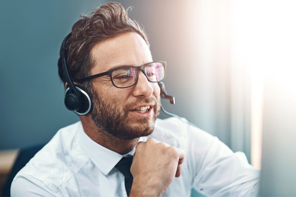 Businessman with headset talking doing cold calling.