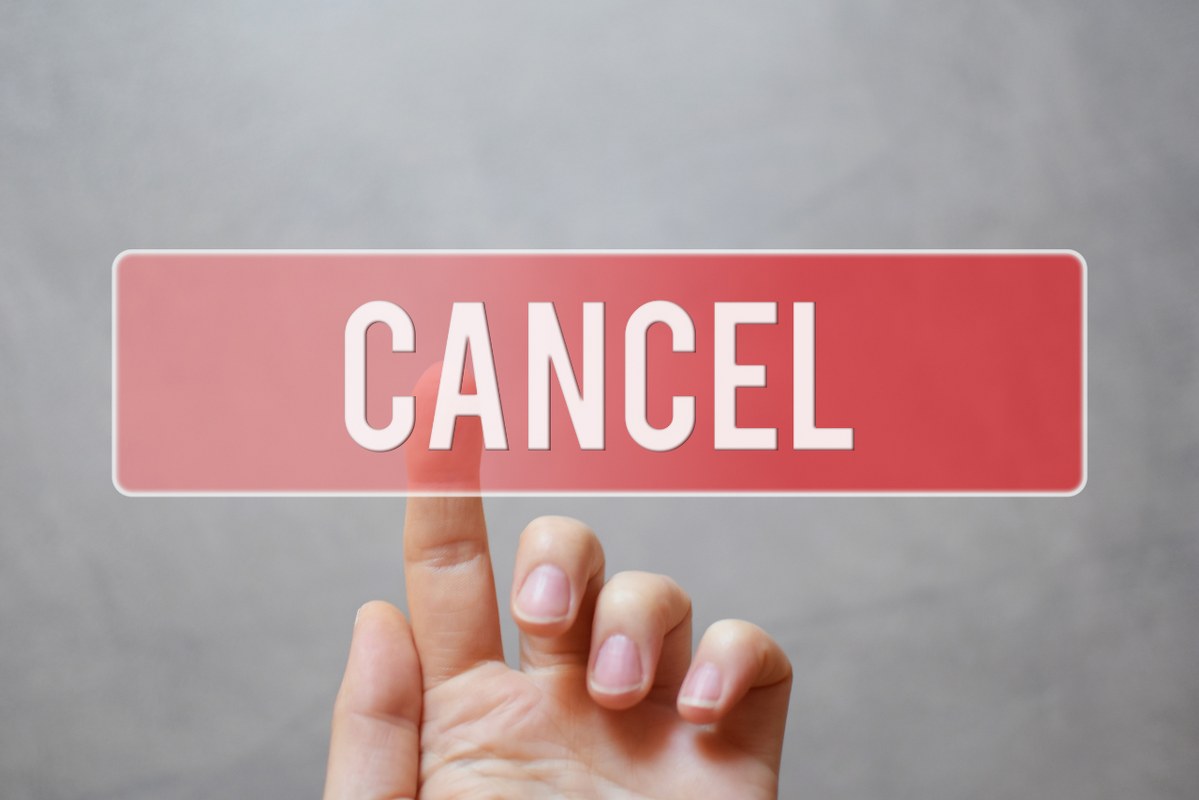 Cancel - hand pressing red transparent button.
