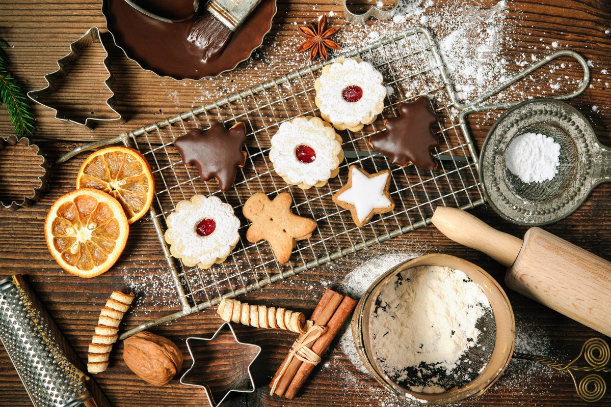 Christmas baking background with cookies, cutter and spices.