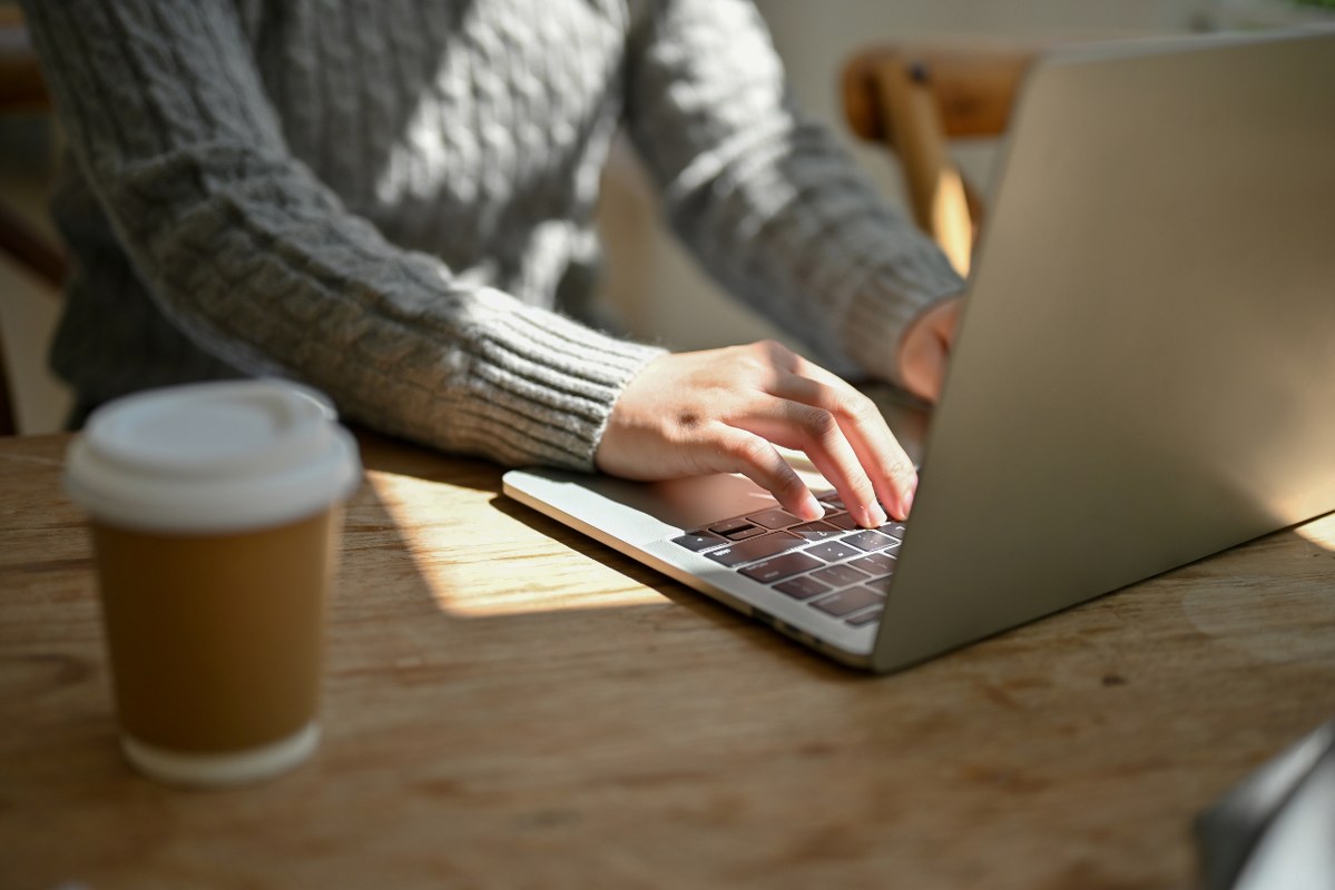 Close-up image of a female freelancer responding to emails.