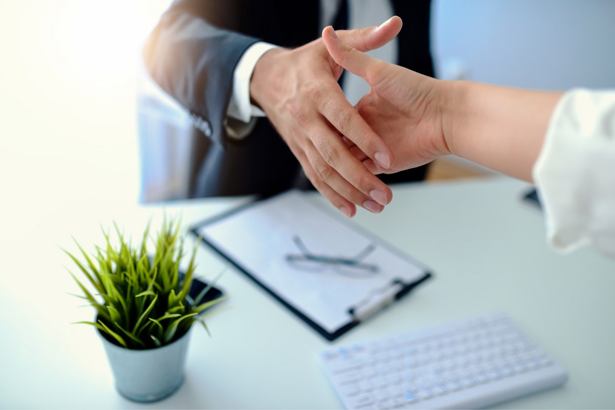 Closing another successful deal by shaking hands.