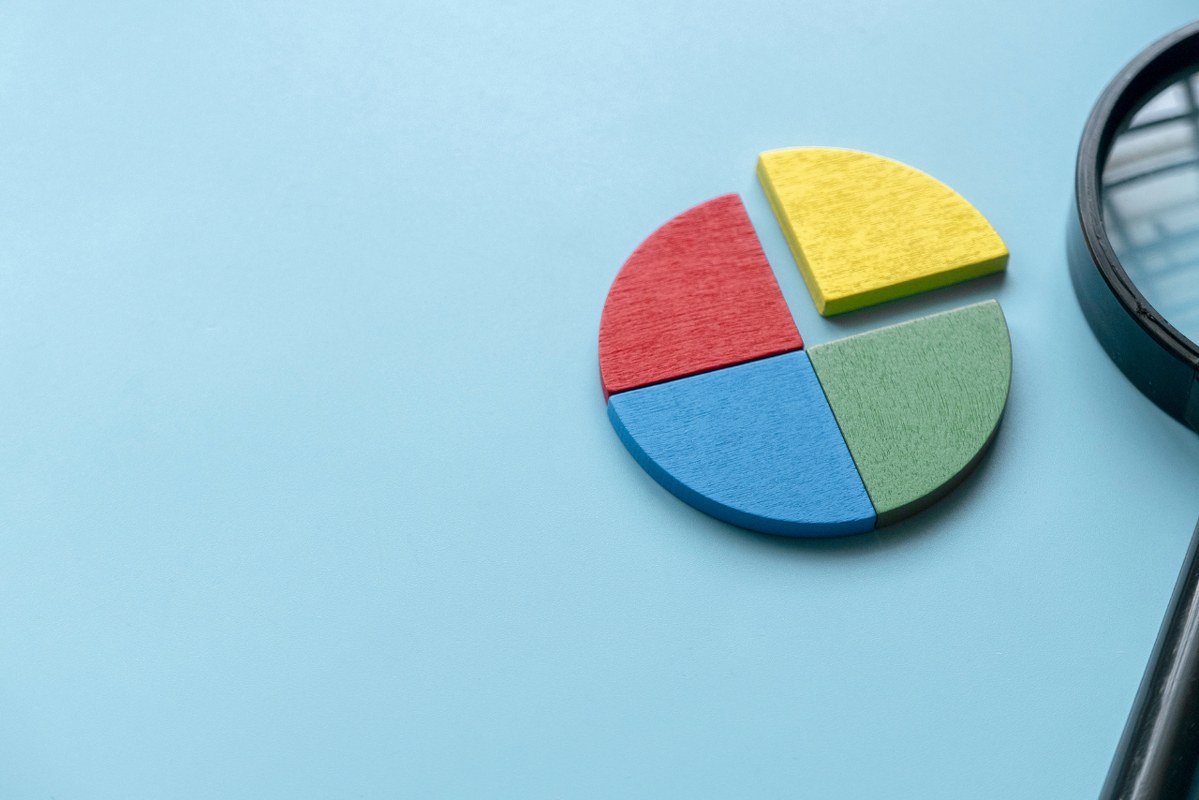 Colorful quarter wooden pie chart pieces.