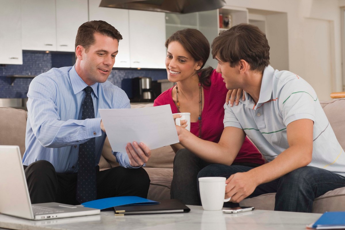 Couple discussing objectives with financial planner.