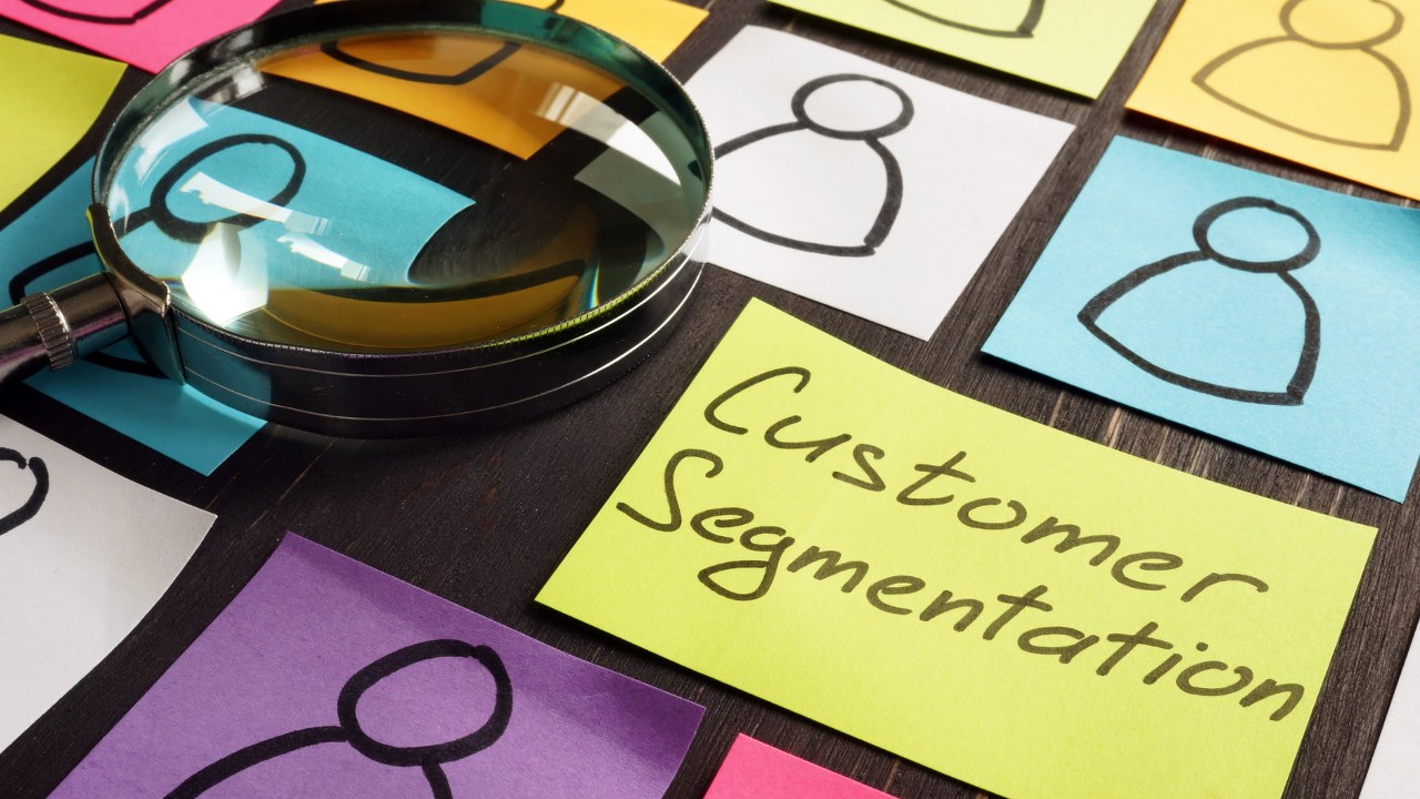 Customer segmentation written on one of sticky notes on table.