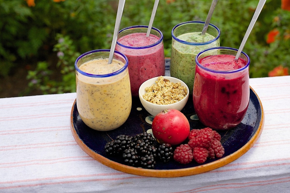 Different fruit smoothies in glasses.