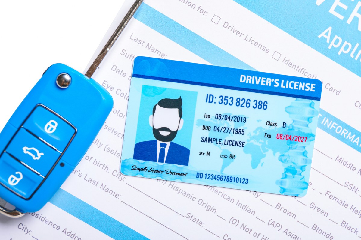 Driving License with Application Form and Car Key, Closeup.