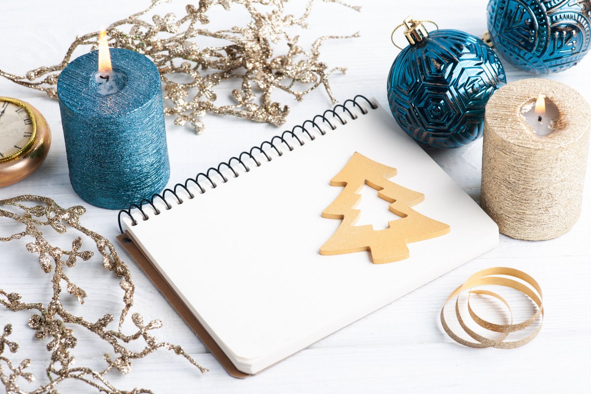 Empty journal with Candles and Christmas Decorations.
