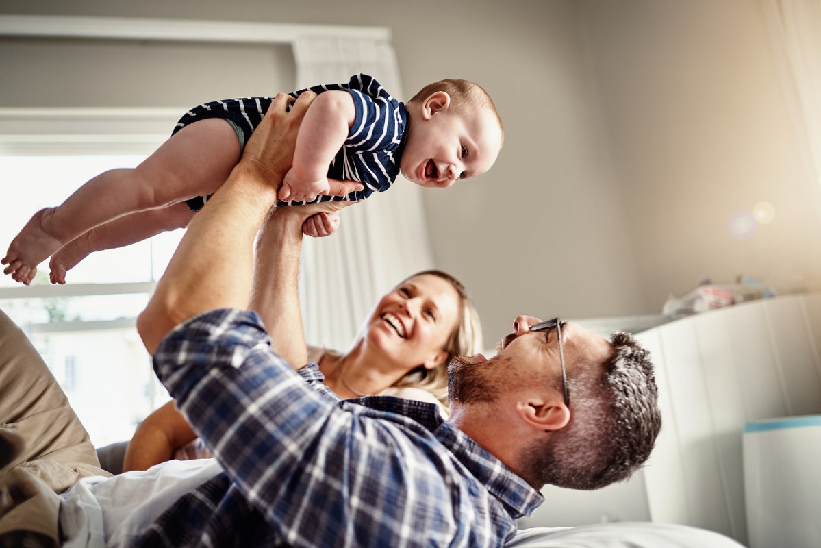 Father and mother playing with baby.
