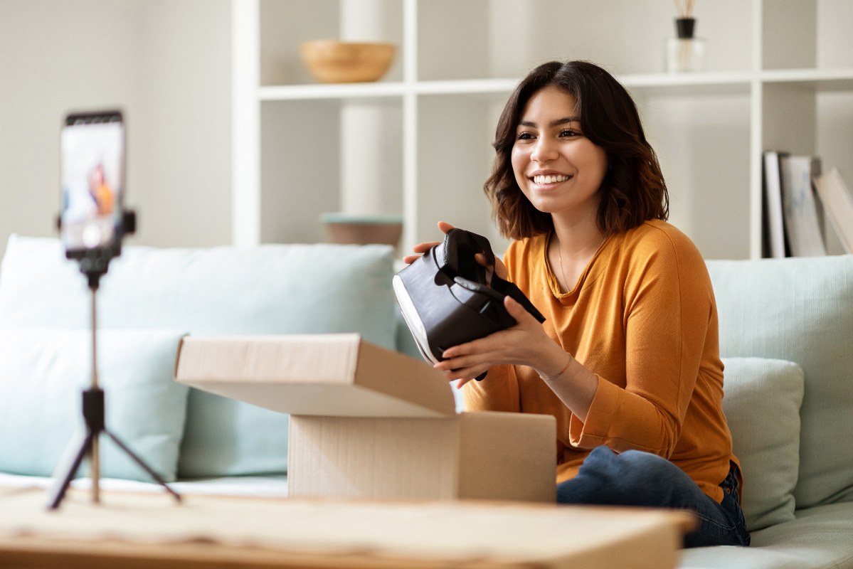 Female Unboxing Parcel With VR Glasses At Camera while recording.