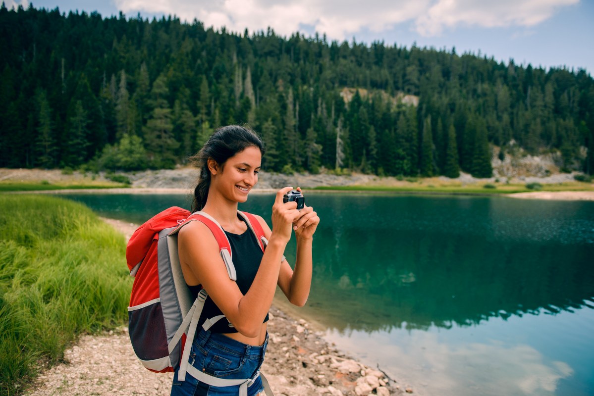 Female travel blogger making video of nature.