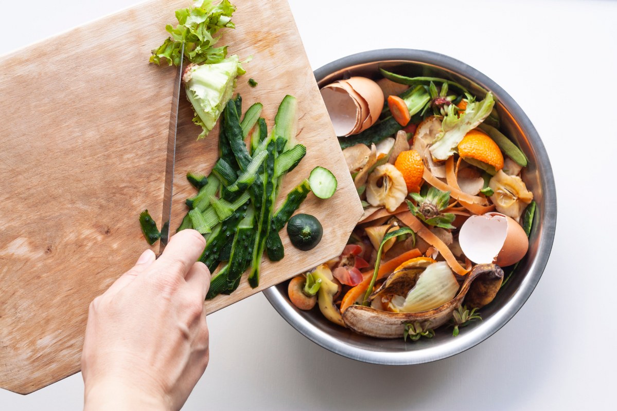 Food waste in iron bowl and cutting board.