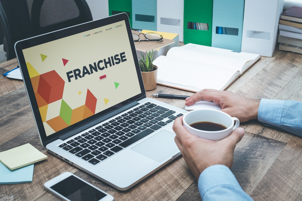 Franchise Business plan presentation title displayed on laptop screen.