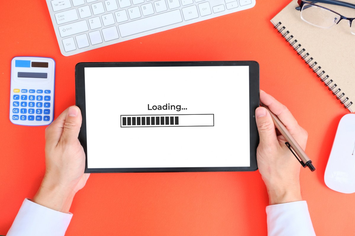 Hand used tablet with concept of improving website loading speed.