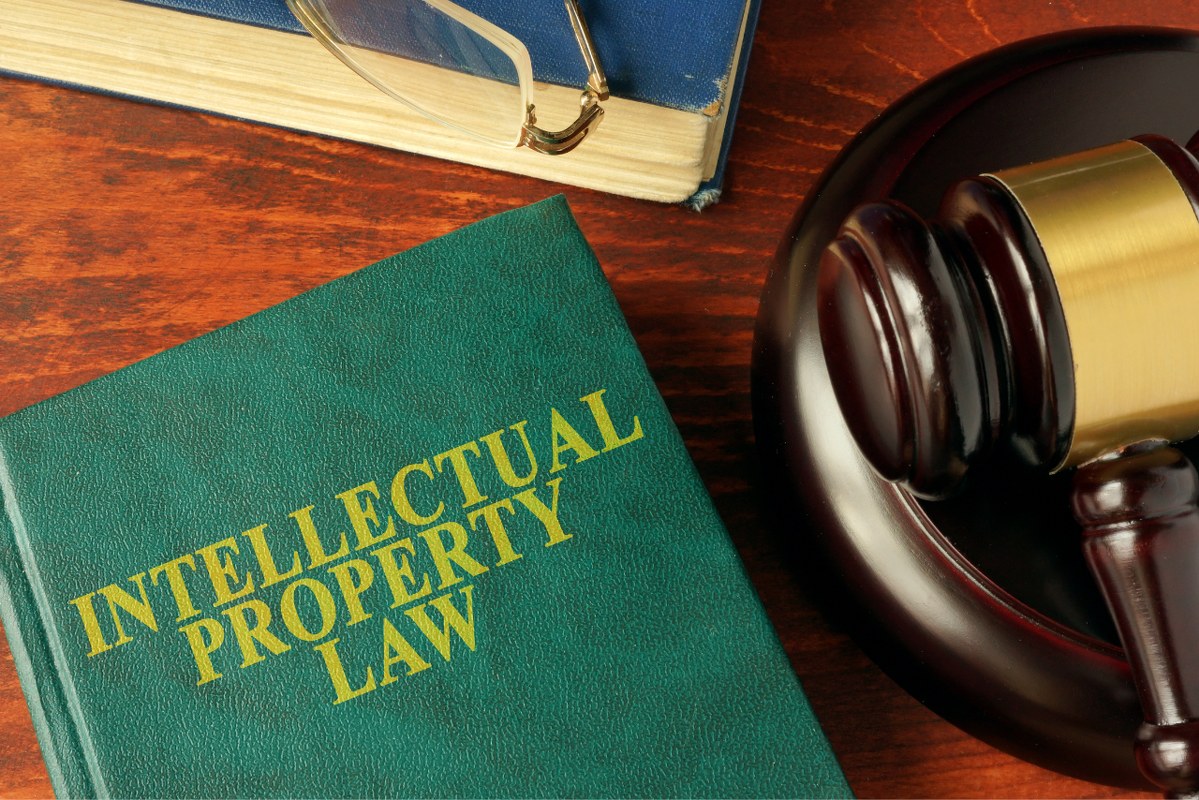 Intellectual property law book on table with gavel.