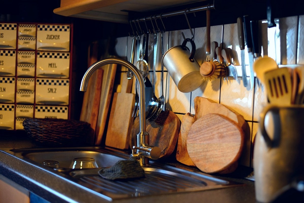 Kitchen utensils on a kitchen sink.