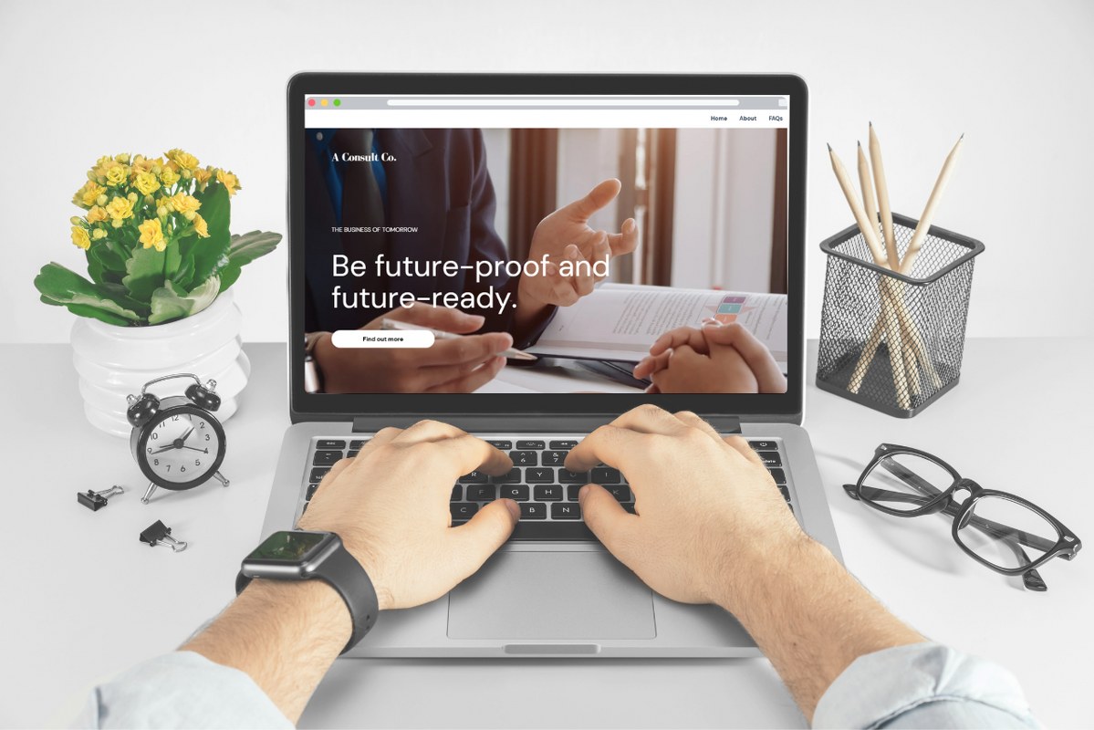 Laptop screen displaying consultant business website mockup.