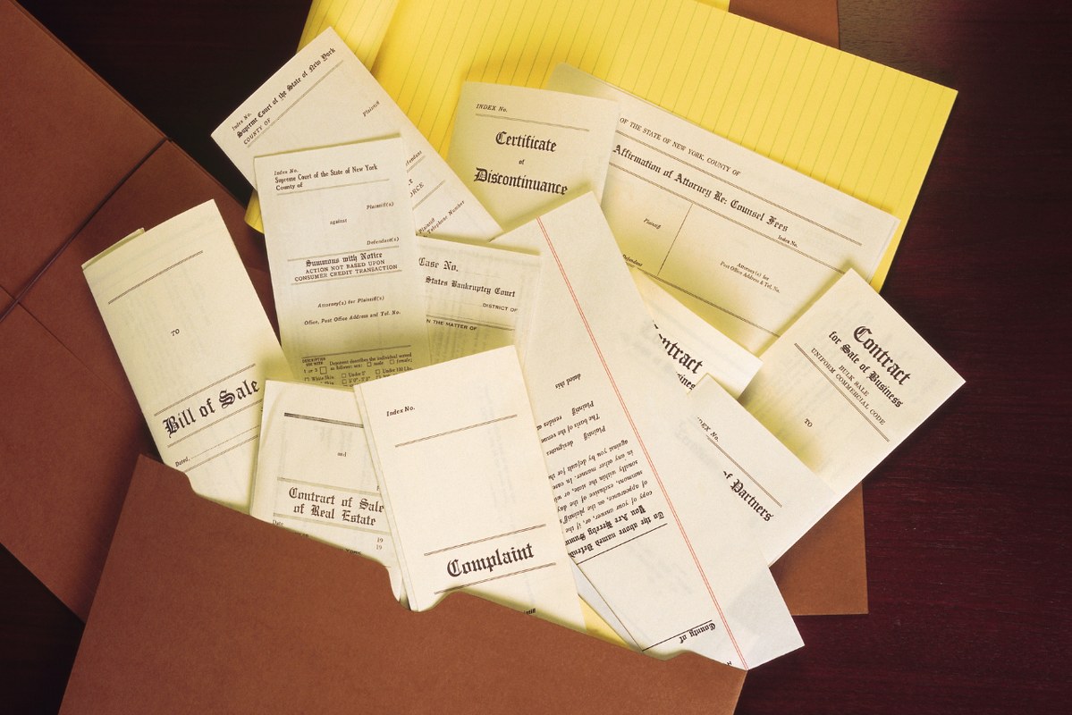 Legal documents burst outside folder.