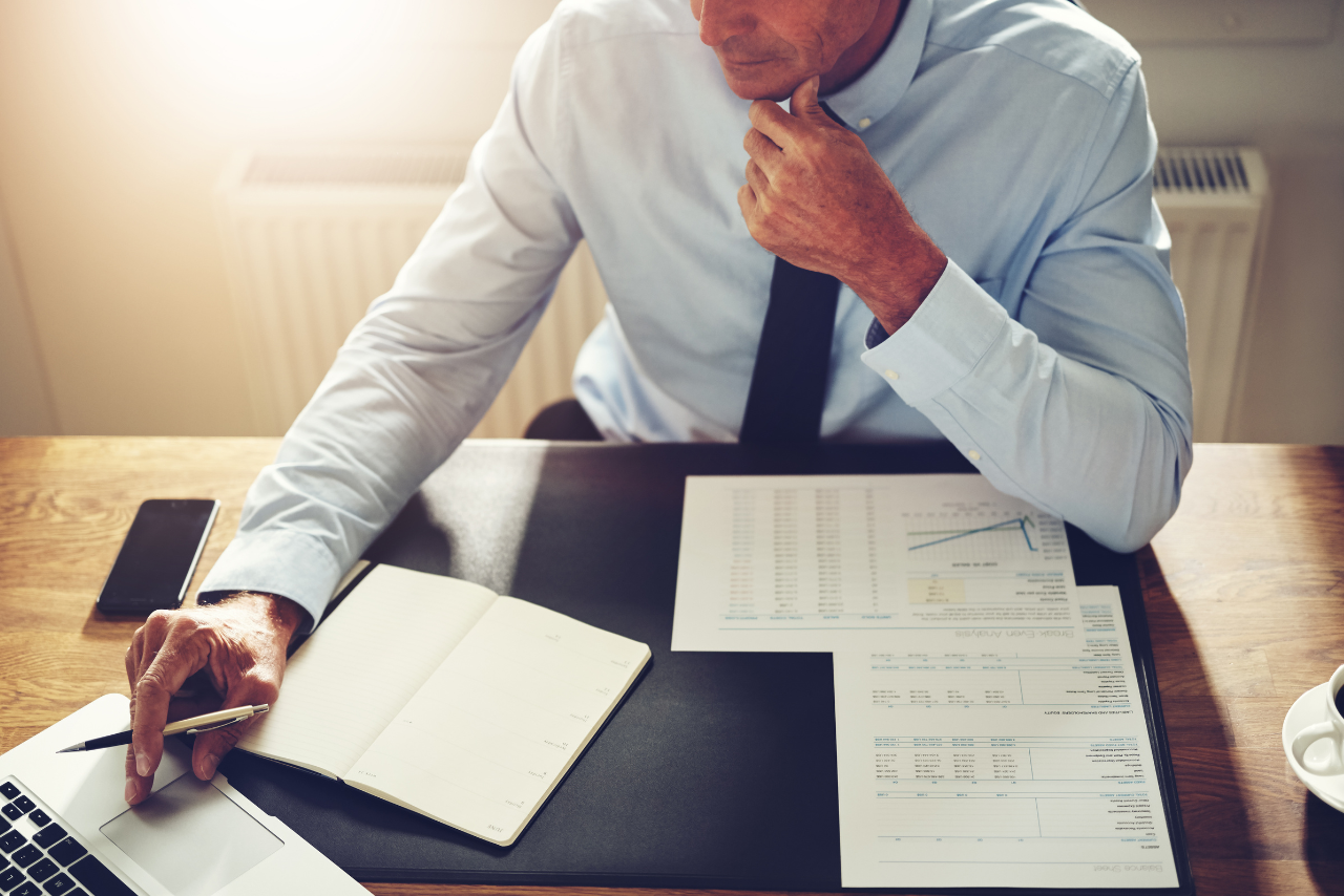 Male Financial Planner working on laptop.