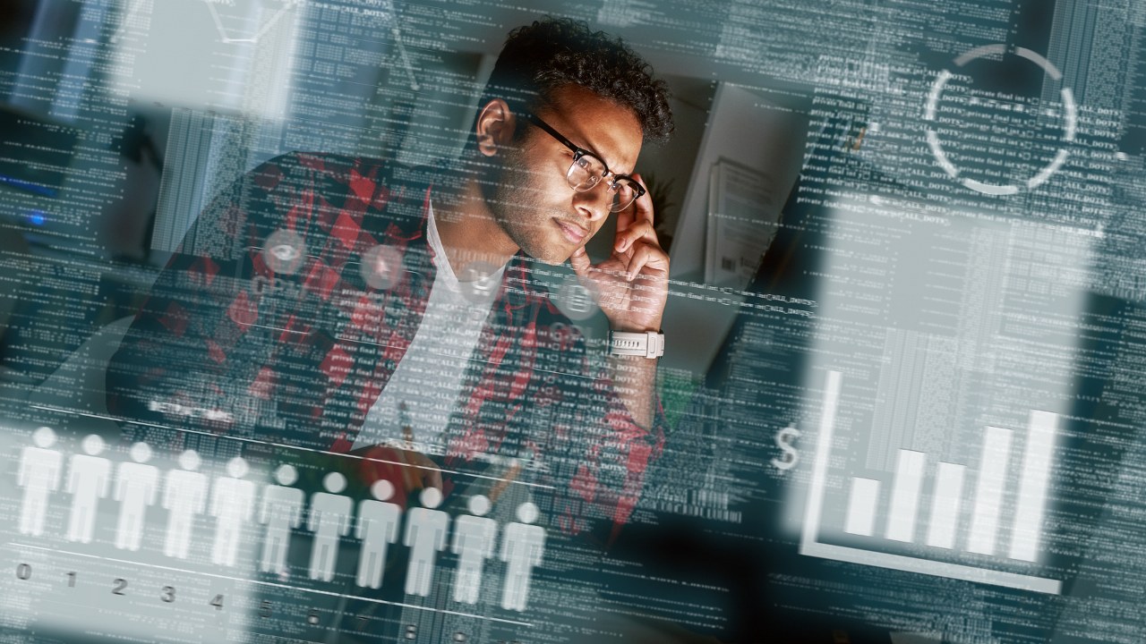 Male SEO specialist focused on monitor screen with holograms.