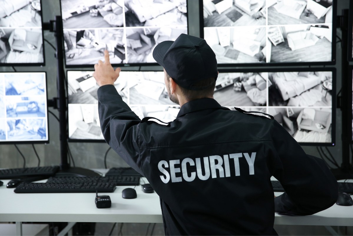 Male Security Guard Working in Surveillance Room.