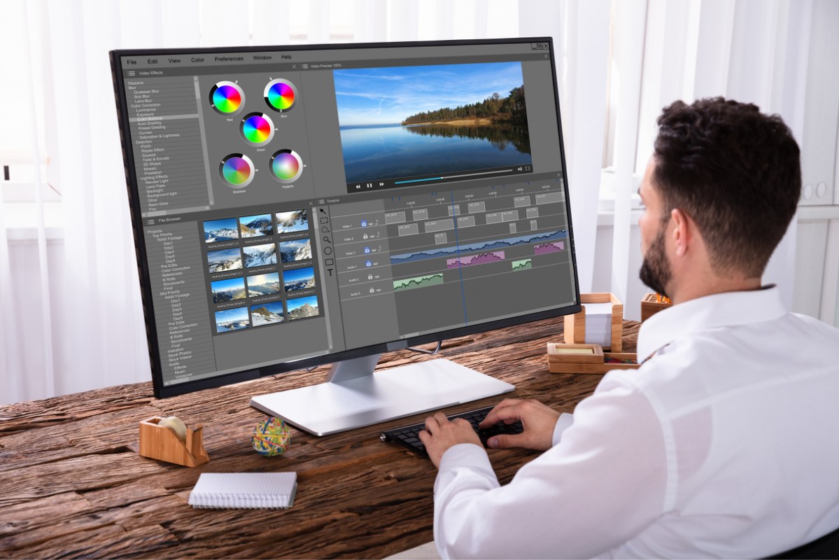 Male editor Editing Video On Computer.