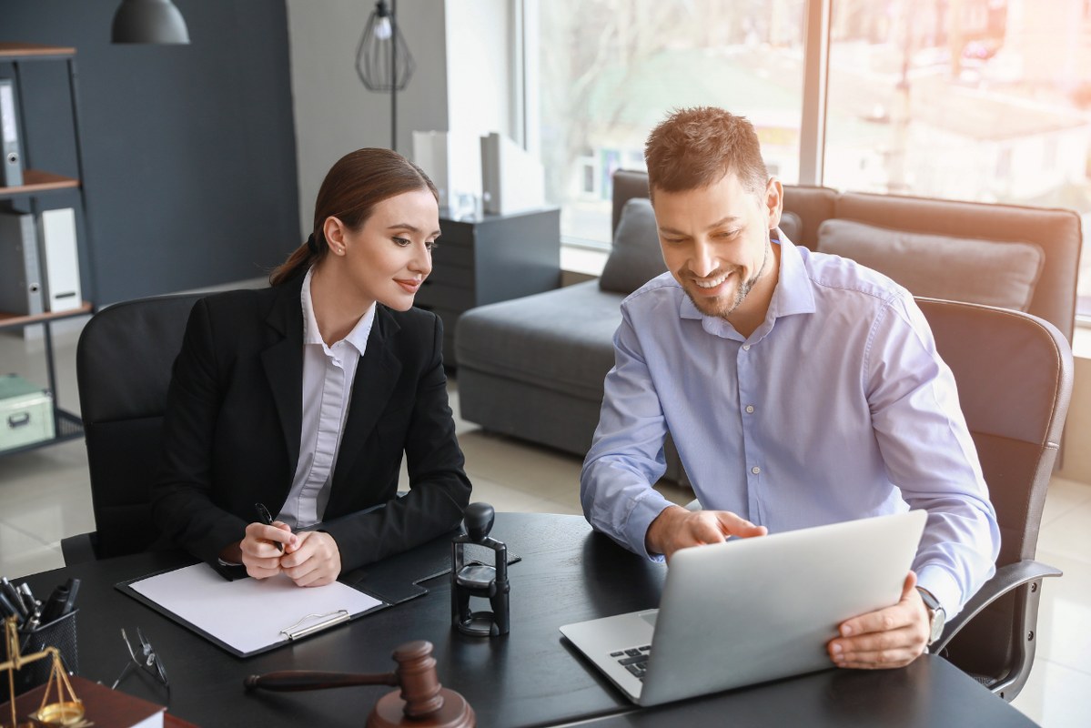 Male lawyer does one-on-one coaching with female client.