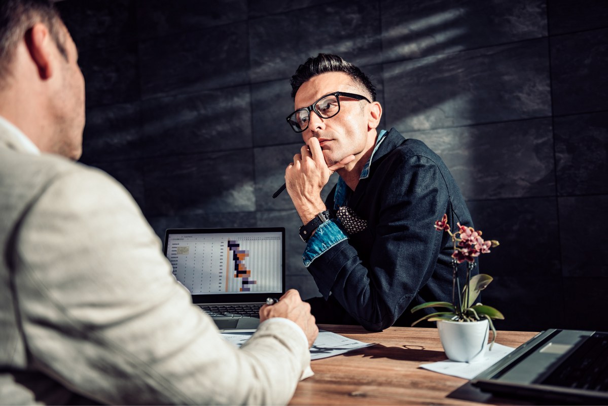 Male person listens attentively and makes eye contact on the other person.