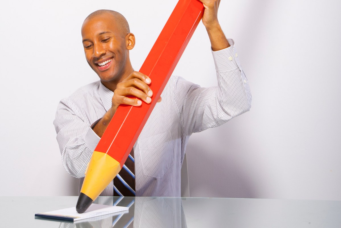 Males have a large pencil in hand.