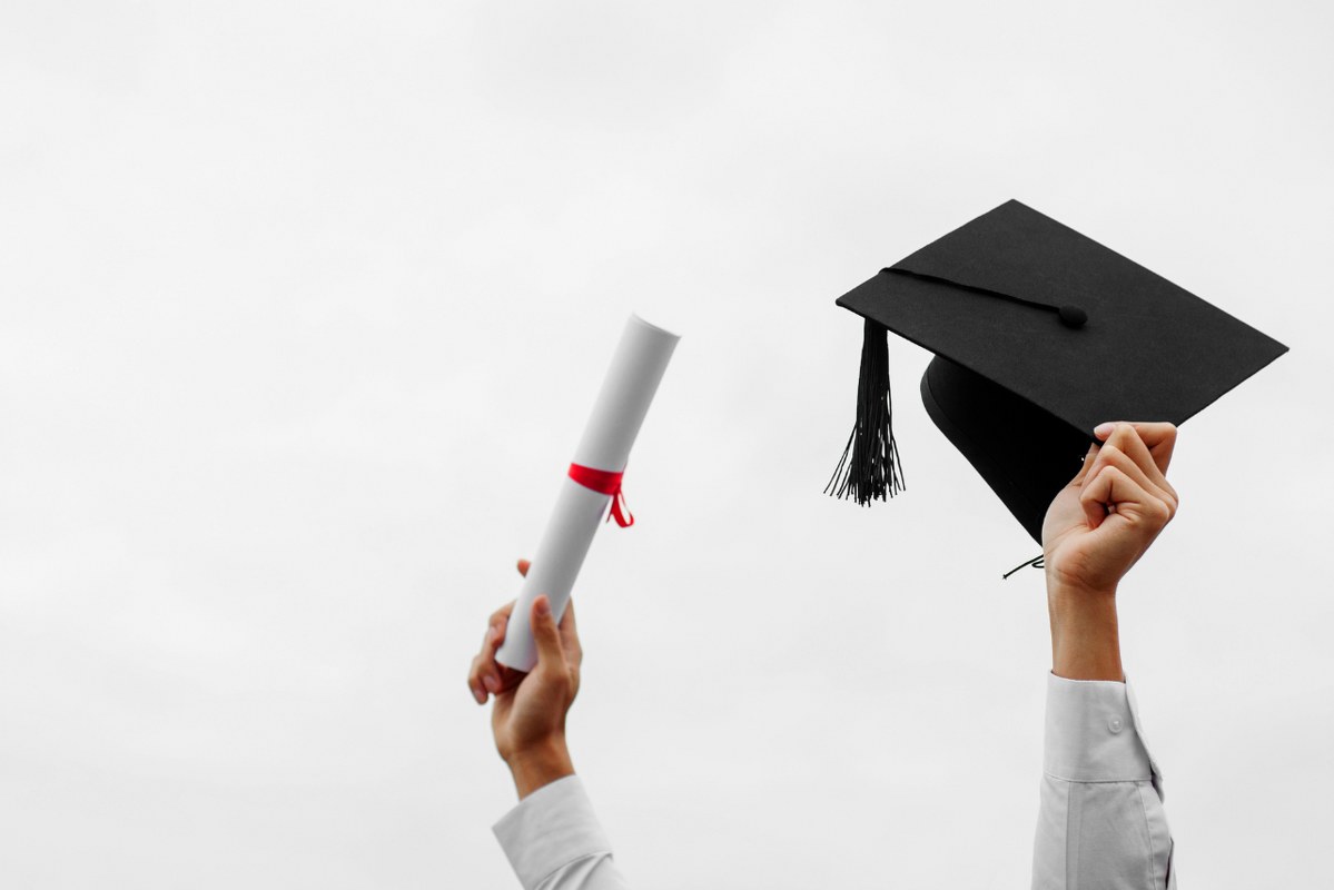 Man hand holding graduation cap, education concept.