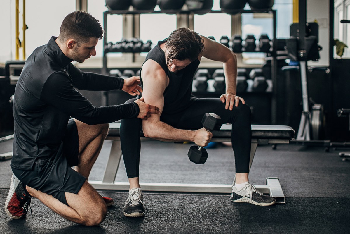 Man having personal training in the gym.