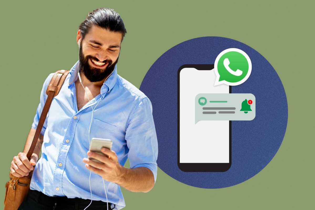Man smiles while looking at phone where he received a marketing reminder from whatsapp.