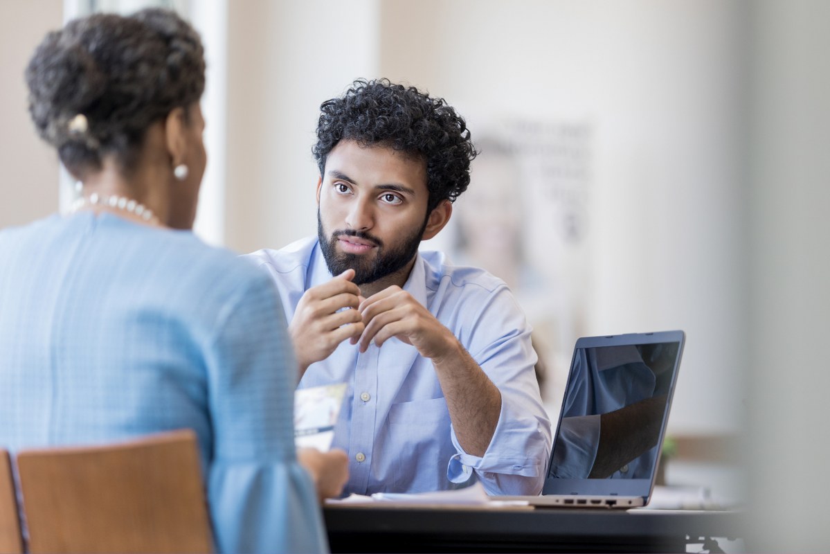 Marketer listening closely to female client's concerns.