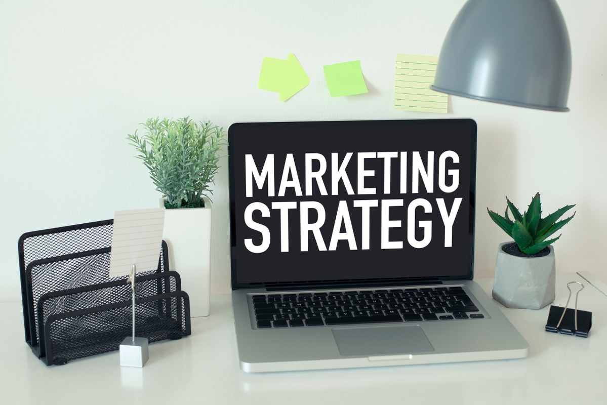 Marketing Strategy words displayed on laptop screen.