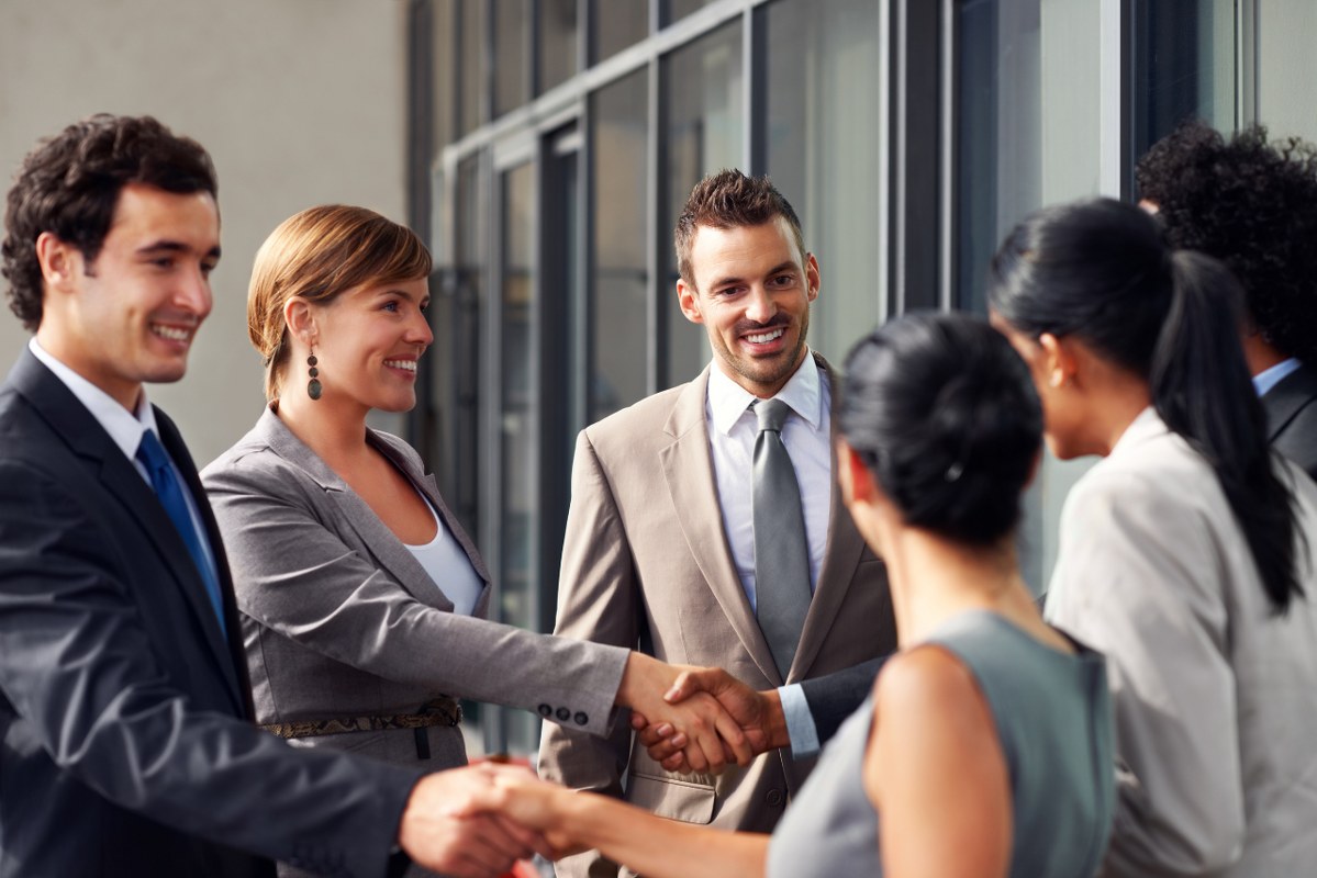 Multiple people shaking hands, forming business relationships that last.
