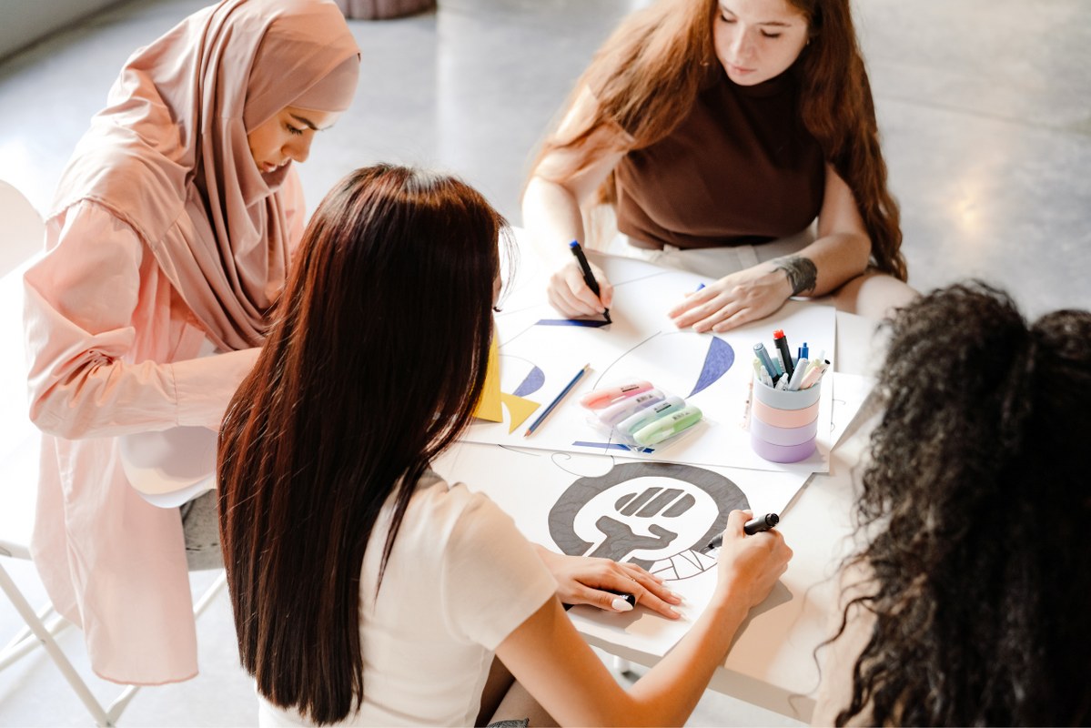 Multiracial Young Women Making Posters.