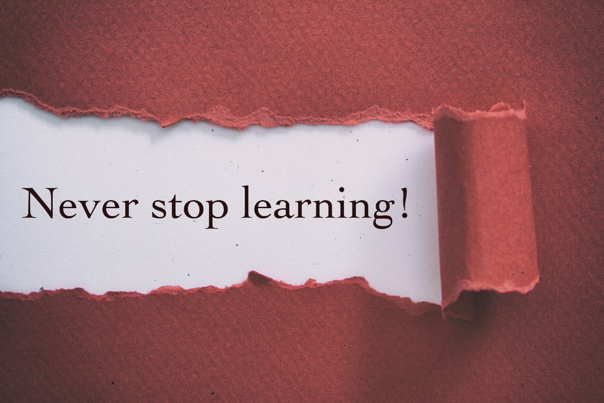 Never stop learning writings on torn paper.