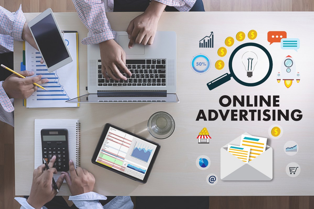 ONLINE ADVERTISING Business team hands at work with financial reports and a laptop.