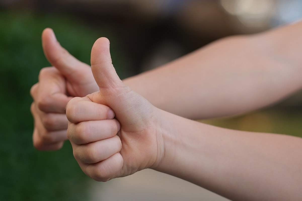 People giving a thumbs-up as a sign of approval.