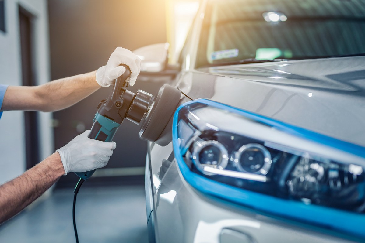 Person Polishing A Car with polisher.